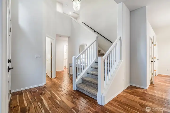 The elegant formal living room greets you upon entry, providing a sophisticated space perfect for receiving guests. This room flows seamlessly into the dining area and den.