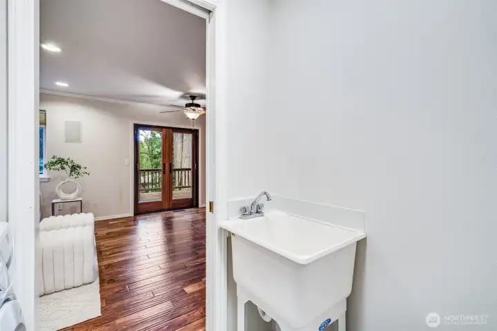 The dedicated main-floor utility room offers essential convenience with space for a washer and dryer, plus overhead cabinetry for storage.