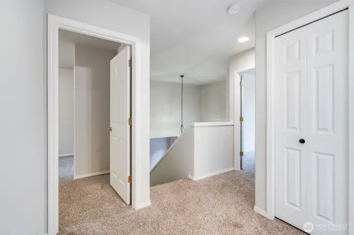 A bright and welcoming second-floor hallway connects all upper-level bedrooms and the full bath. Ample natural light creates an airy, open feeling.