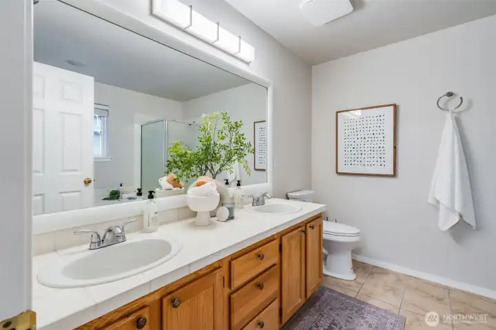 The elegantly designed five-piece master bath features a timeless, classic aesthetic. With a deep, separate soaking tub and a spacious walk-in shower, it offers a sophisticated retreat grounded in enduring style.