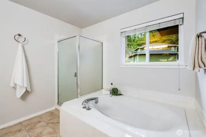 The elegantly designed five-piece master bath features a timeless, classic aesthetic. With a deep, separate soaking tub and a spacious walk-in shower, it offers a sophisticated retreat grounded in enduring style.