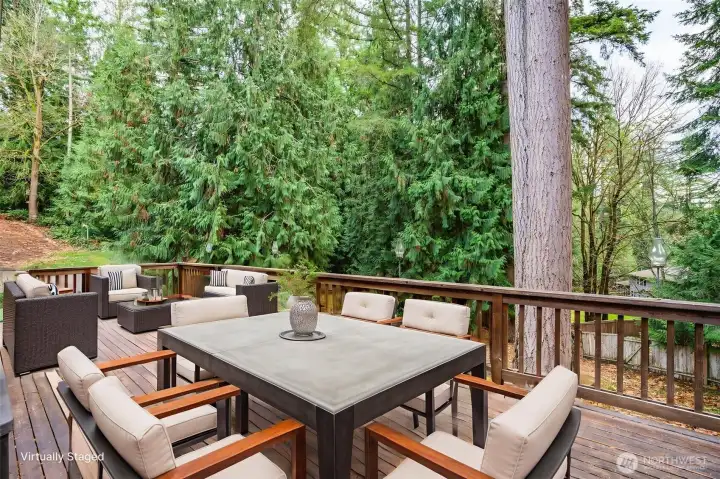 A beautiful, spacious deck overlooking the private backyard. Perfect for outdoor dining and entertaining. Virtually Staged