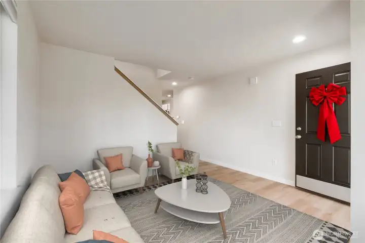 Virtually Staged. Sun-soaked living room highlighted by a large picture windows, crisp new interior paint, and stylish new flooring—creating an airy, welcoming first impression as you step inside.