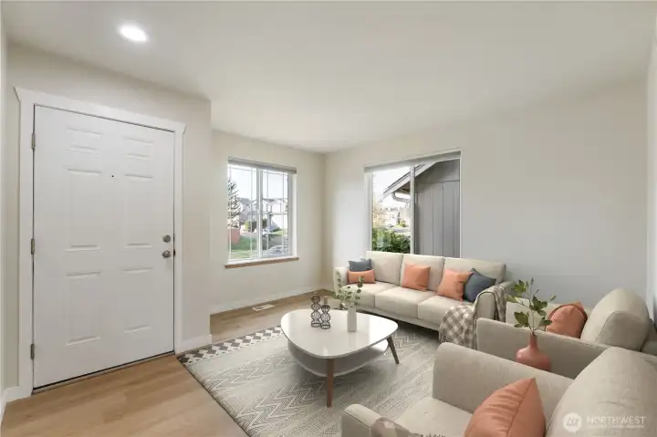 Virtually Staged. Sun-soaked living room highlighted by a large picture windows, crisp new interior paint, and stylish new flooring—creating an airy, welcoming first impression as you step inside.