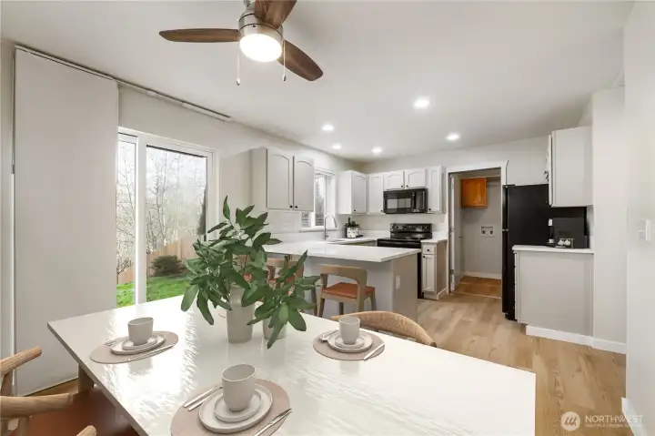 Virtually Staged. Beautifully updated kitchen showcasing new quartzite counters for timeless durability, refreshed cabinetry, modern appliances, and an eat-in bar ideal for entertaining or everyday dining.