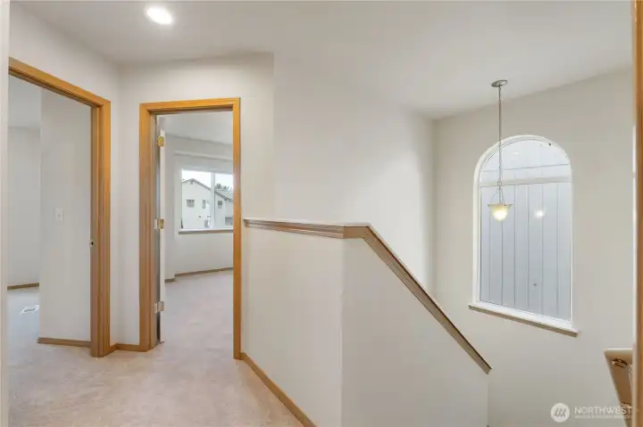 Sun-filled stairwell featuring a large picture window and beautiful natural light.