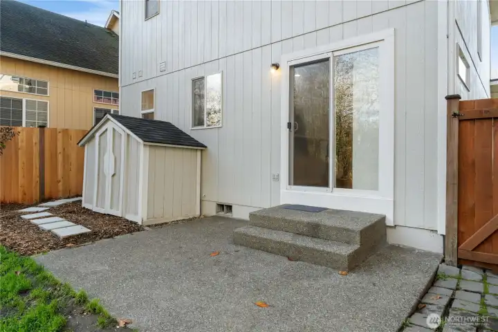 Fully fenced backyard with patio, ideal for entertaining and outdoor living.