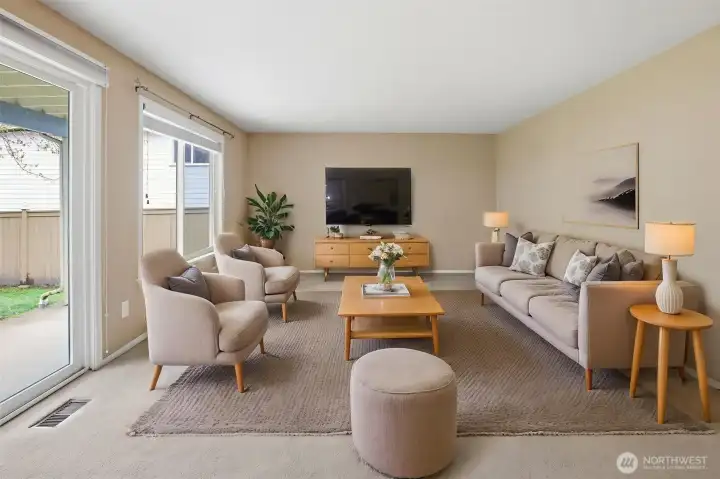 Virtually staged living room with sliders out to a private covered patio