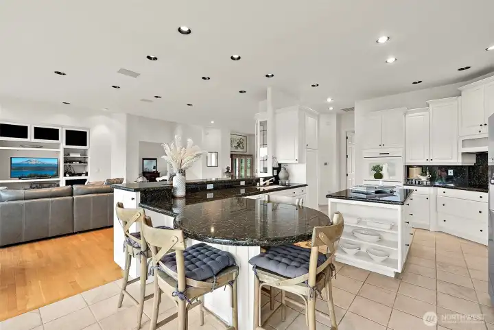 Entertainer's Kitchen Showcases Abundant Cabinetry, Granite Slab, Prep Island, & Island Seating.