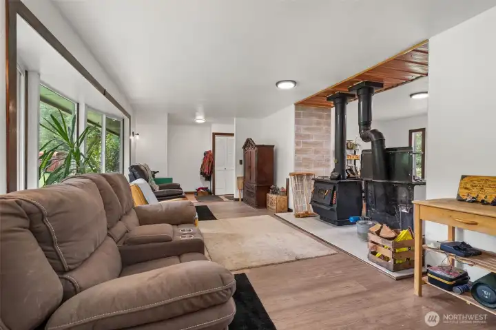 Looking toward the entry with view of wood stove and wood cooktop stove