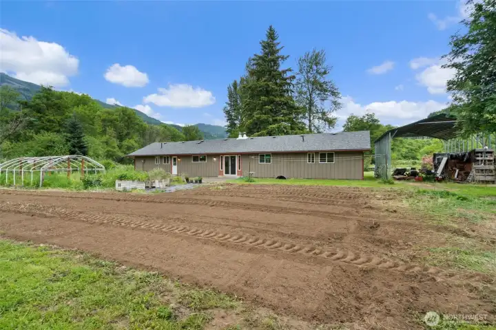 Garden space; recently tilled and back of home plus RV parking to the right