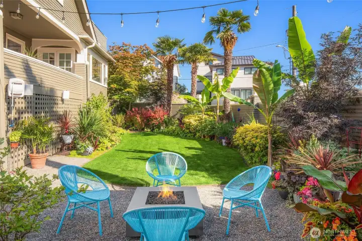 Tropical-inspired landscaping creates a private, resort-like setting.