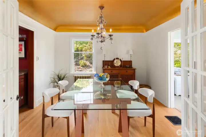 Formal dining   room with a stylish wet bar and French doors.