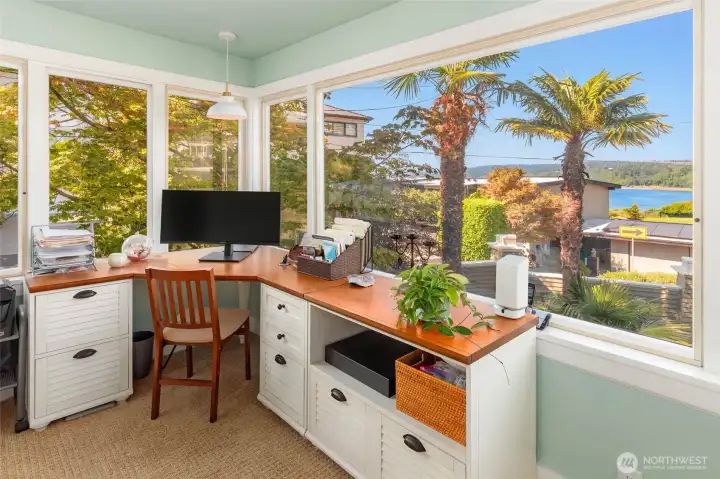 Solarium office area with views and French doors opening to front porch.