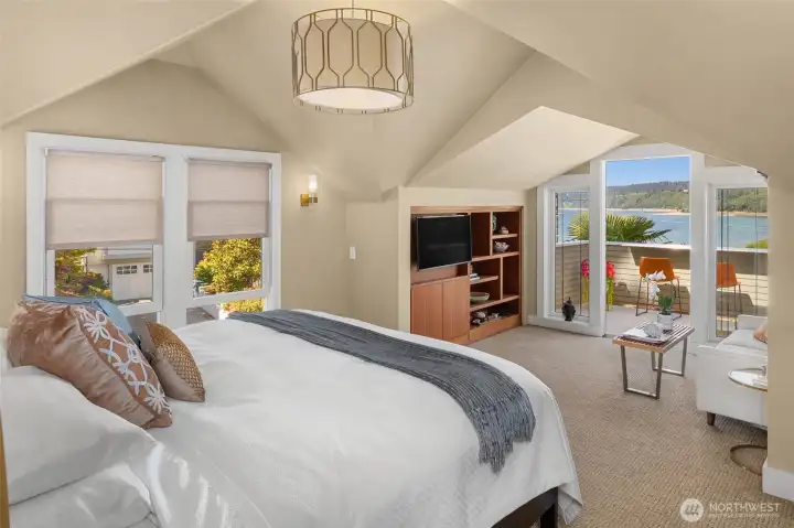 Primary suite with   vaulted ceilings, a sitting area, spa-inspired bath,   generous walk-in closet, and private view deck.