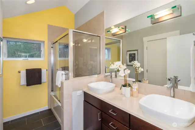 The Primary bathroom with radiant heat tile floors, double sink vanity and walk-in closet await you!