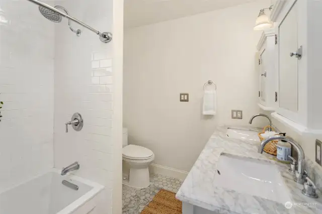 Upstairs full bathroom with double sinks.