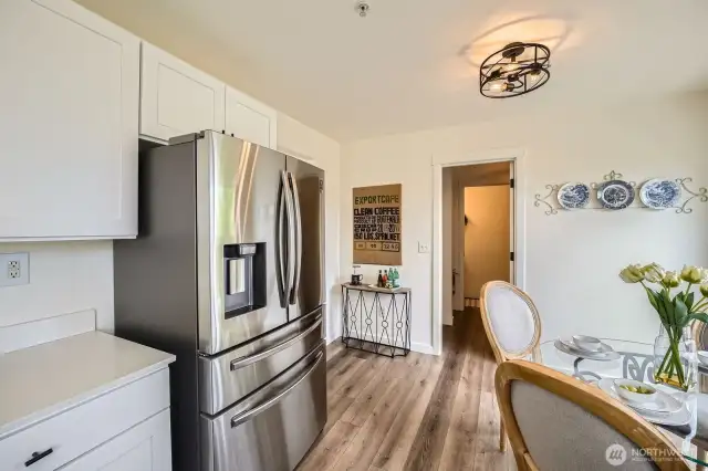 Kitchen and dining area connect with a powder room and backdoor patio areas.