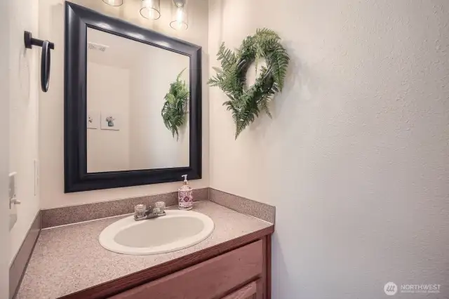 Powder room is conveniently located on first floor for visitors off of the laundry room area.