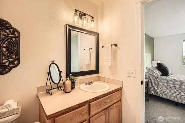 Convenient and private bathroom connects with primary bedroom.