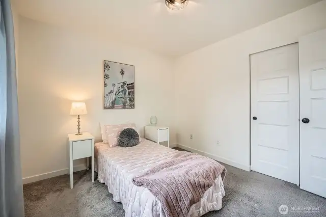 This move-in ready townhouse has beautiful modern details throughout, such as the closet doors seen in this bedroom.