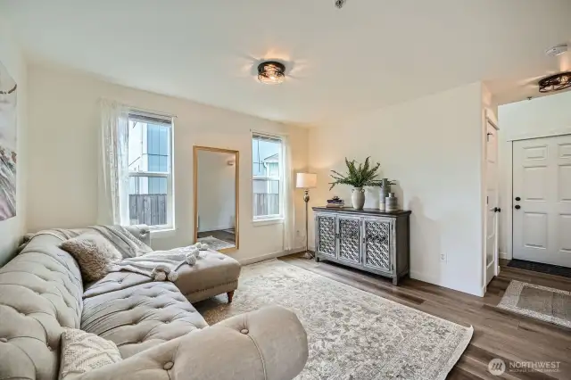 Living room has lots of natural light, and connected with an entry area coat closet with ample storage.