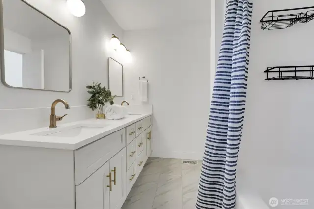 Primary ensuite, double vanity, ceramic tile floors, quartz counter, gold fixtures