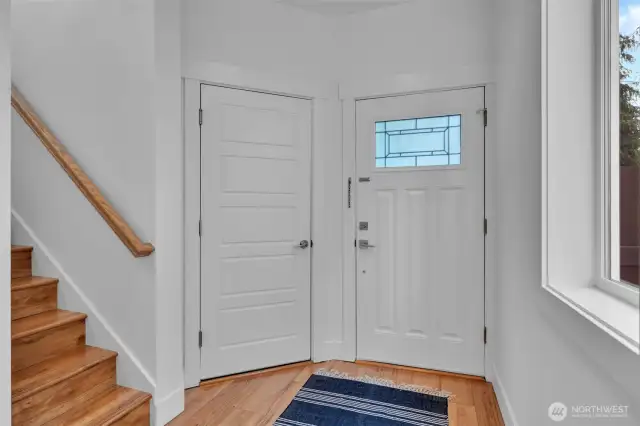 Entry, steps to second floor, door on left to garage