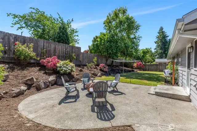 What a great patio!  Room for picnic table and chairs, BBQ, Fire pit, chaise lounge!  Perennial bushes with blooming color.