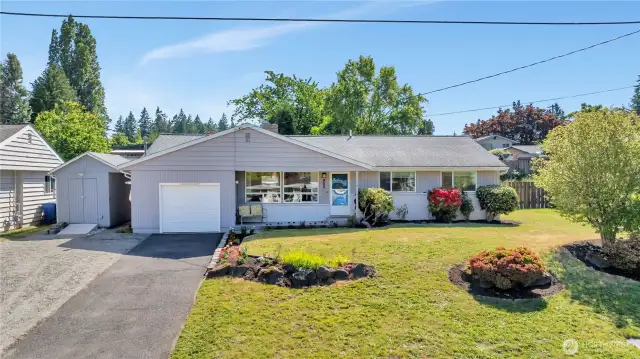 The structure to the immediate left of the house and garage with a small ramp has power.  It's a great bonus storage area for lawn equipment, garden supplies, bikes, sports gear, and other seasonal supplies.  The graveled parking area in front of the storage structure is easily used for additional off-street parking.