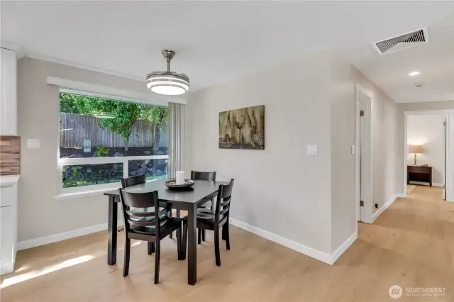 Dining Area has a nice view of the back yard.  A  row of roses in front of the window provides a beautiful bouquet of color.  Windows open for a nice cross breeze, and the light fixture is also a fan with dual direction options.