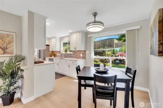 Dining Area adjoins the kitchen. Light fixture also has a built in fan over the dining table to help keep the house cool on warm summer days.