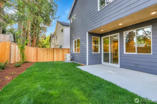 Fully fenced backyard with covered patio.
