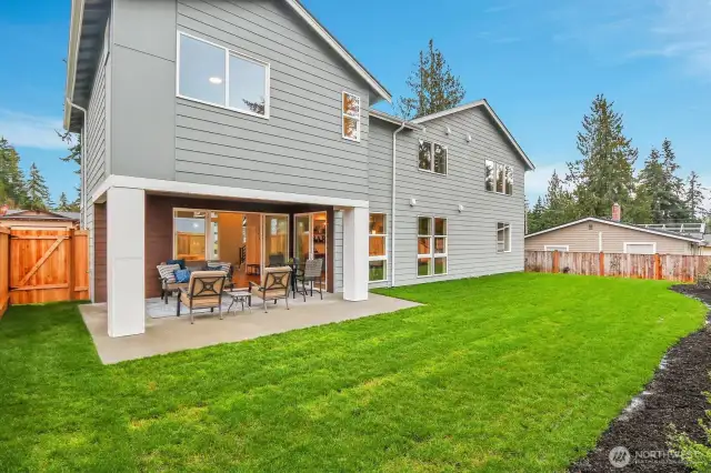 The covered outdoor living space ensures comfort in every season.