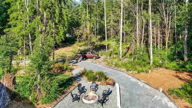 The firepit area, all graveled easy to walk to with manicured trails bordering by ferns and forest