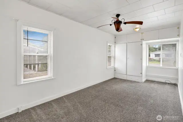 Primary bedroom with great light and ceiling fan.