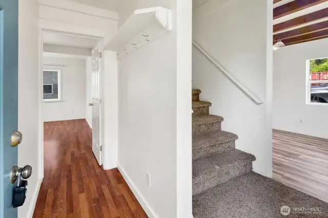 Covered entry with stairs leading to second floor, office to the left, and down the hall to 1st bedroom with no closet, or second living area.