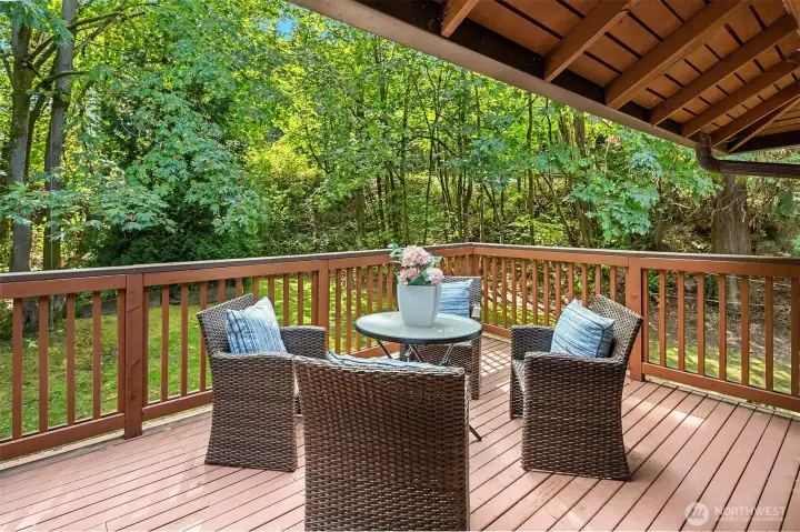 Private and peaceful back deck overlooks the large backyard