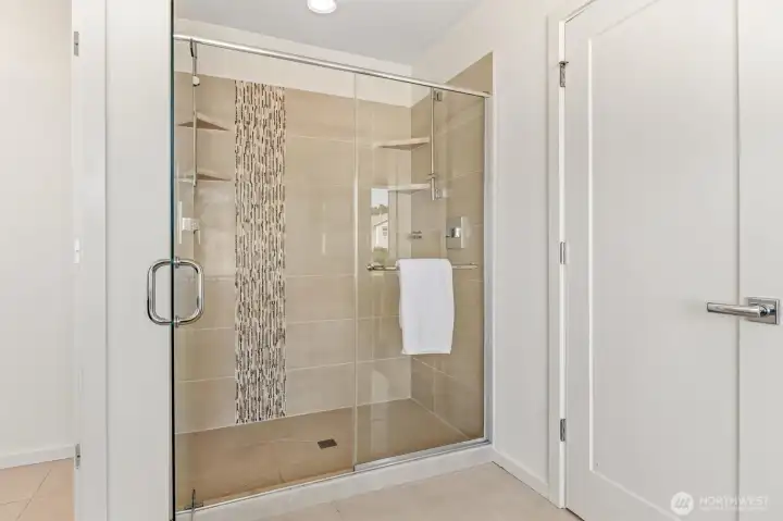Walk-in shower in primary suite has two shower heads