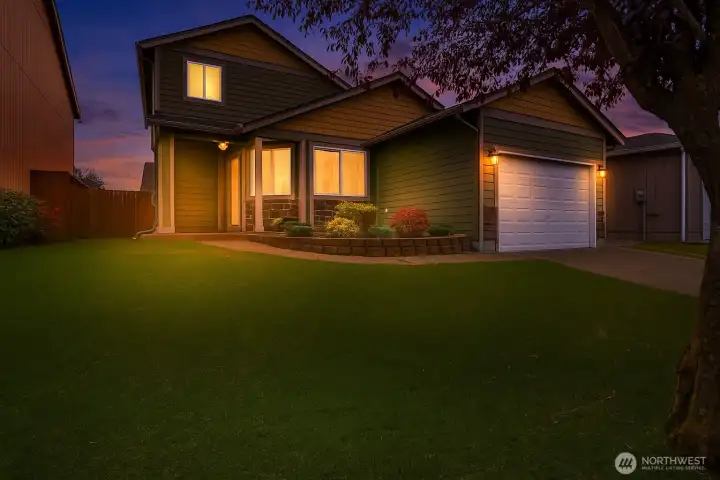 This stunning twilight view highlights the home’s warm glow and inviting curb appeal. A perfect blend of charm and comfort—beautifully showcased day or night. Virtually staged