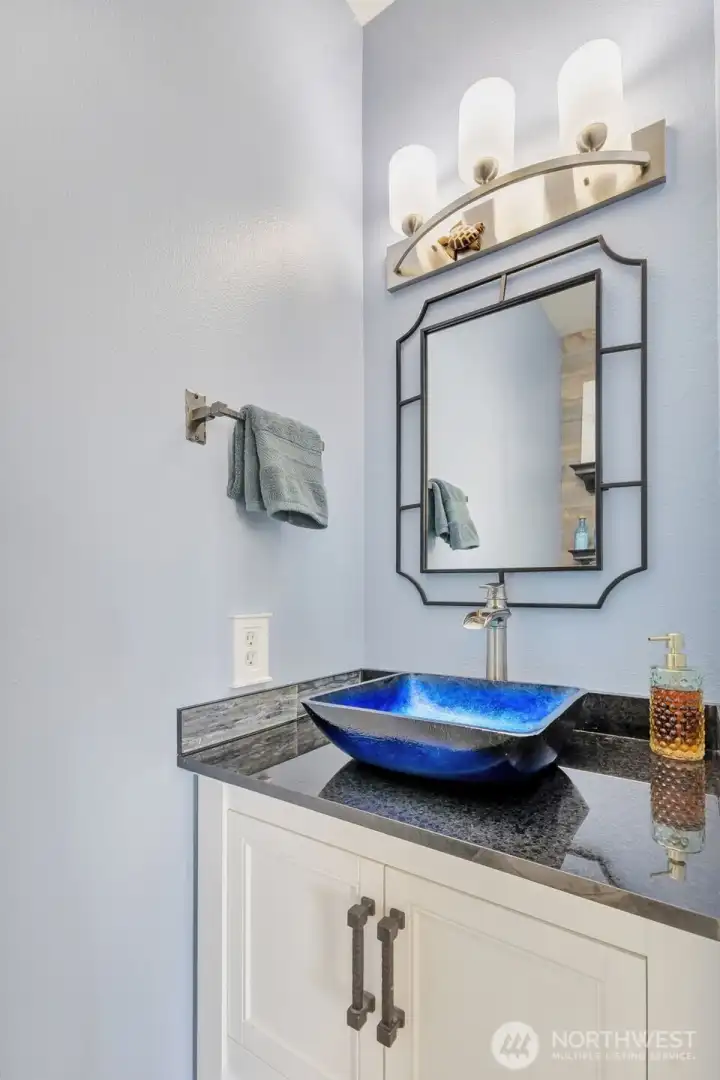 1/2 bath on main floor had new vanity, granite countertop and custom glass vessel sink