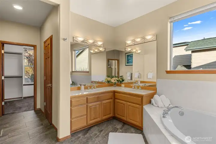 Ensuite bathroom with soaking tub and large walk in closet
