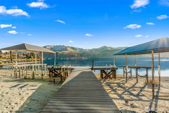 Premium boating amenities including a shared dock with covered boat lift, and three personal buoys.