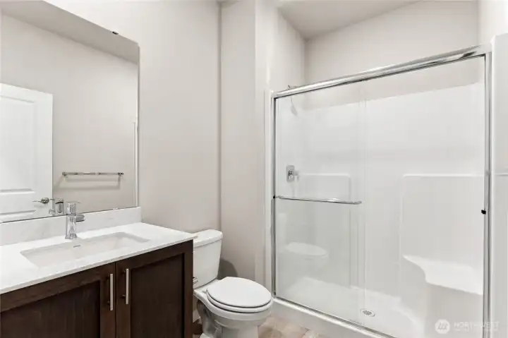 Lower level 3/4 bath is handy to the main floor guest bedroom/office