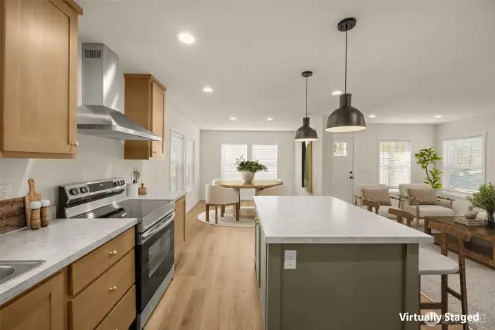 Virtually staged view from kitchen looking toward the front door, dining room, and living room