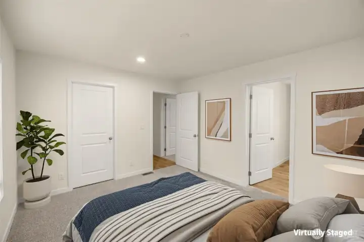 Virtually staged primary suite with attached bath to the right