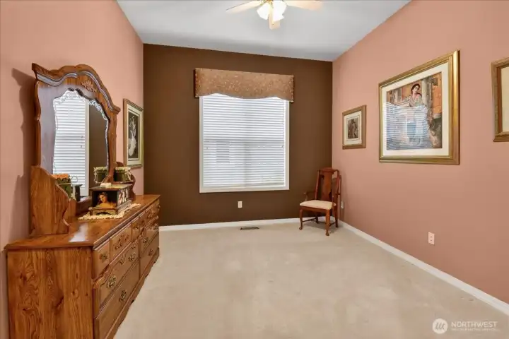 Your guest room is fashionably painted with a lighted ceiling fan, a matching valance, and attached full-bath.