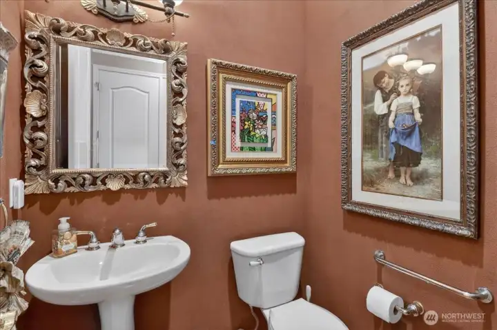 Powder Room with tile flooring, faux paint, and lavish Mirror and lighting fixtures.