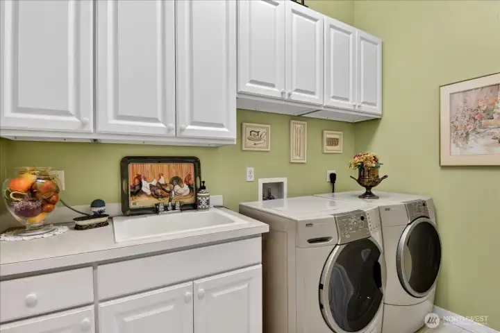 Your dream laundry room provides abundant storage, wash basin, folding counter, custom paint, Solar tube, and a fabulous set of Kenmore Elite front load washer and dryer.