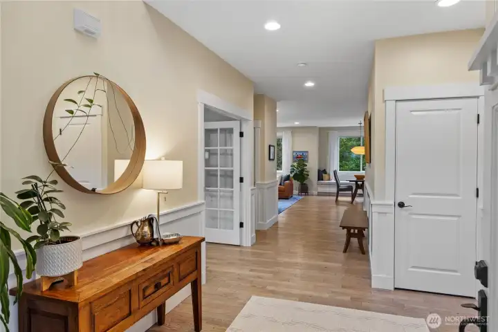 You'll instantly feel welcomed by the wide entryway, with lovely hardwood floors and quality features like wainscoting throughout the main level.